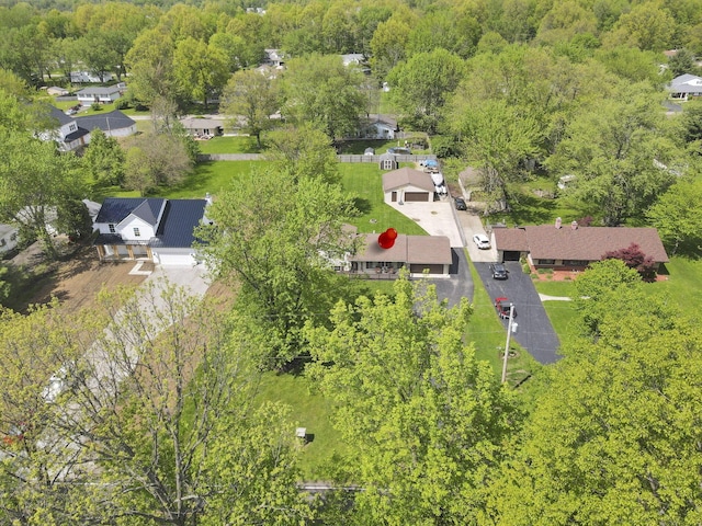 aerial perspective of suburban area featuring a heavily wooded area