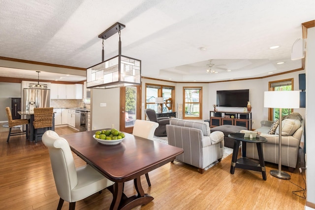 3690 Christopher Pl, Grove City, OH 43123 - dining room with a ceiling fan, light wood-style floors, a tray ceiling, crown molding, and recessed lighting