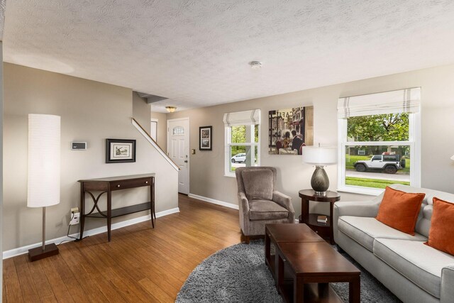 3690 Christopher Pl, Grove City, OH 43123 - living area featuring wood finished floors, baseboards, a textured ceiling, and stairway