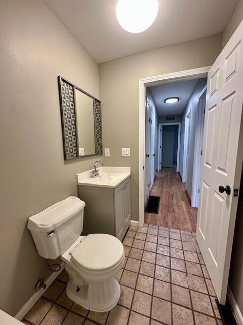 3128 Parsons Ave, Columbus, OH 43207 - bathroom with toilet, vanity, and baseboards