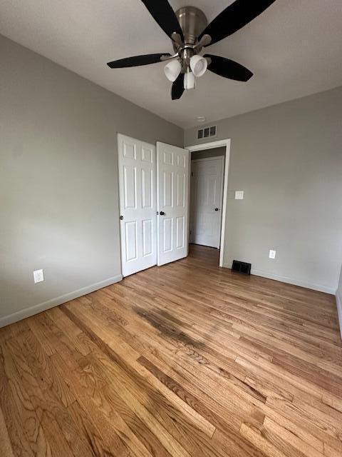 3128 Parsons Ave, Columbus, OH 43207 - unfurnished bedroom with baseboards, light wood finished floors, and a ceiling fan