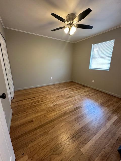 3128 Parsons Ave, Columbus, OH 43207 - empty room featuring crown molding, wood finished floors, baseboards, and ceiling fan