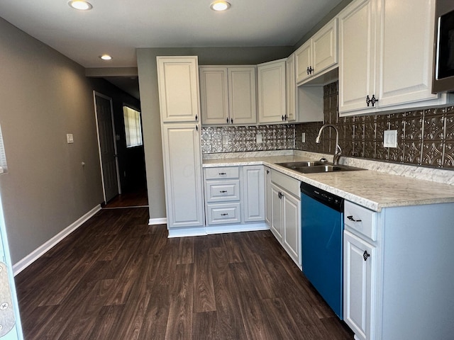 3128 Parsons Ave, Columbus, OH 43207 - kitchen with a sink, dishwasher, dark wood-style flooring, light countertops, and decorative backsplash