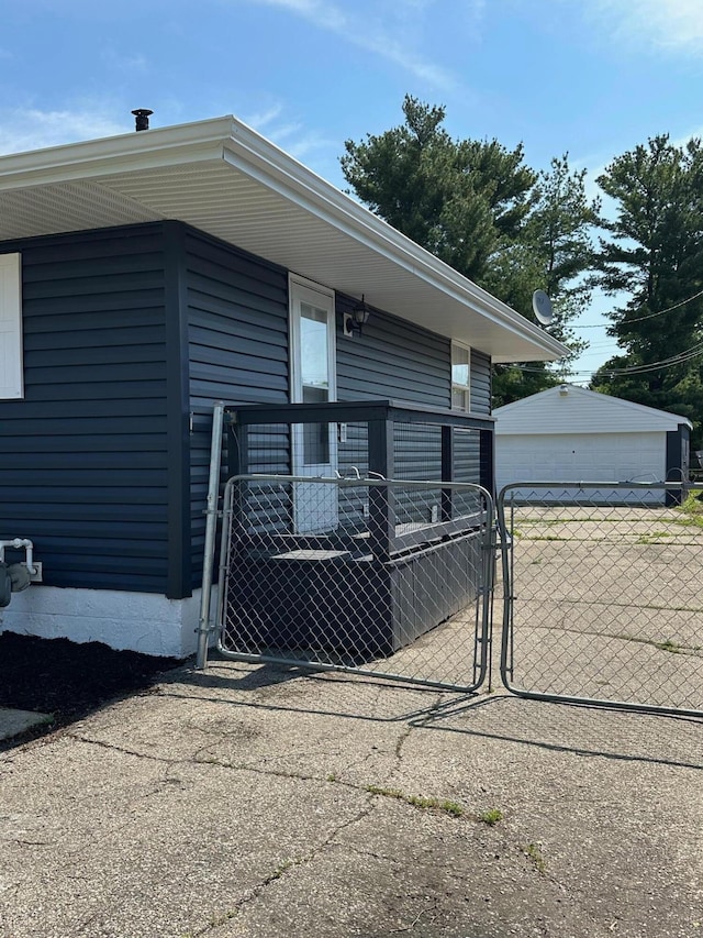 3128 Parsons Ave, Columbus, OH 43207 - view of side of property featuring a gate, fence, an outdoor structure, and a garage