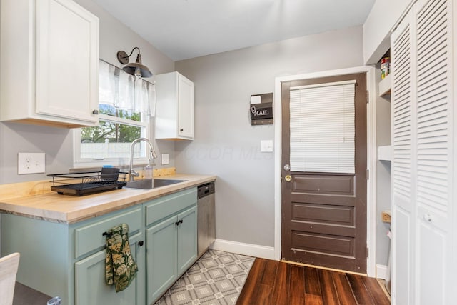 259 Merriman Dr, West Jefferson, OH 43162 - kitchen with a sink, stainless steel dishwasher, butcher block counters, white cabinetry, and baseboards