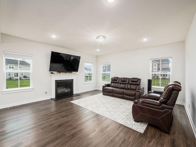 418 Amethyst Ct, Delaware, OH 43015 - living room with dark wood-type flooring, baseboards, a glass covered fireplace, and recessed lighting