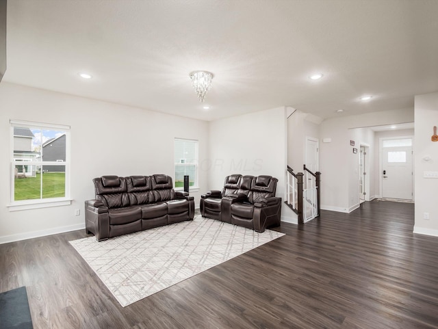 418 Amethyst Ct, Delaware, OH 43015 - living room with dark wood finished floors, baseboards, stairway, recessed lighting, and a chandelier