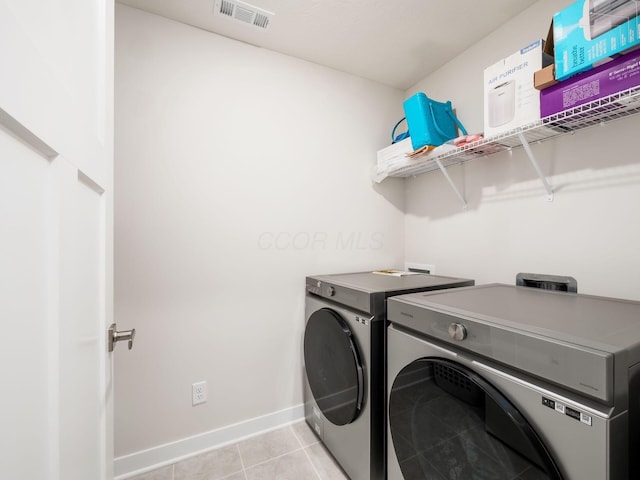 418 Amethyst Ct, Delaware, OH 43015 - clothes washing area featuring washer and clothes dryer, baseboards, and light tile patterned flooring