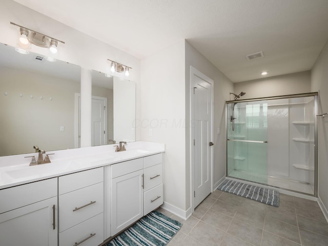 418 Amethyst Ct, Delaware, OH 43015 - bathroom with a shower stall, tile patterned flooring, double vanity, and baseboards