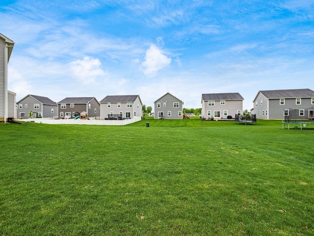 418 Amethyst Ct, Delaware, OH 43015 - view of grassy yard with a trampoline, a residential view, and a patio area