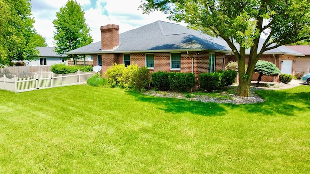 1320 Oakridge Dr, Bucyrus, OH 44820 - back of house featuring a chimney and brick siding