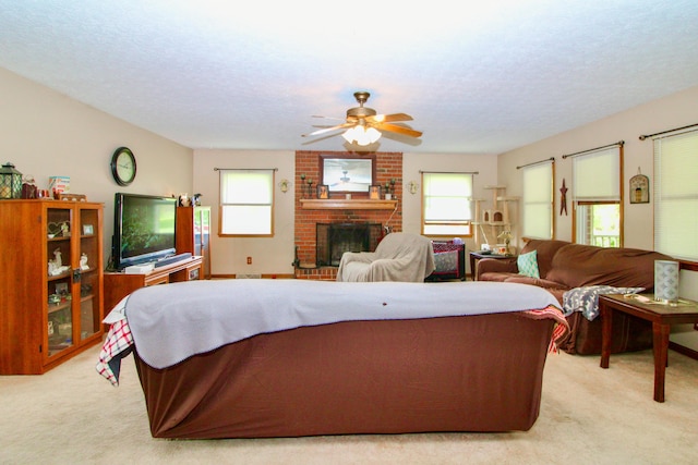 1320 Oakridge Dr, Bucyrus, OH 44820 - living room with light colored carpet, a ceiling fan, a fireplace, and a textured ceiling