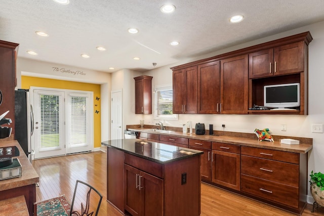 6227 Marias Point Ln, Columbus, OH 43213 - kitchen with a sink, light wood finished floors, a kitchen island, recessed lighting, and stainless steel appliances