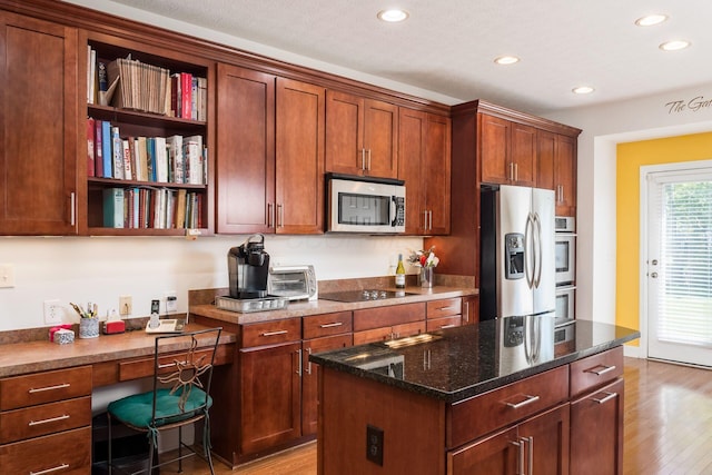 6227 Marias Point Ln, Columbus, OH 43213 - kitchen with stainless steel appliances, recessed lighting, wood finished floors, open shelves, and dark stone countertops