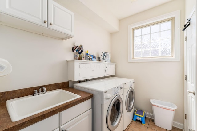 6227 Marias Point Ln, Columbus, OH 43213 - washroom featuring washing machine and clothes dryer, cabinet space, and light tile patterned floors