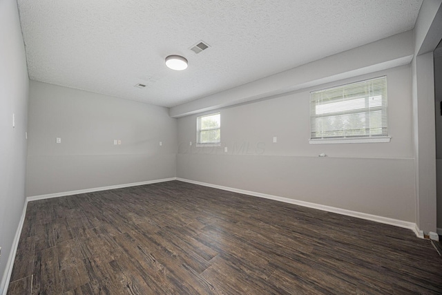 9721 State Rte 521, Sunbury, OH 43074 - spare room featuring dark wood-style flooring, a textured ceiling, and baseboards