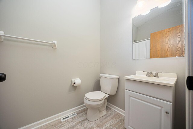 9721 State Rte 521, Sunbury, OH 43074 - bathroom featuring wood finished floors, vanity, baseboards, and toilet