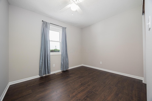 9721 State Rte 521, Sunbury, OH 43074 - unfurnished room featuring dark wood finished floors, baseboards, ceiling fan, and a textured ceiling