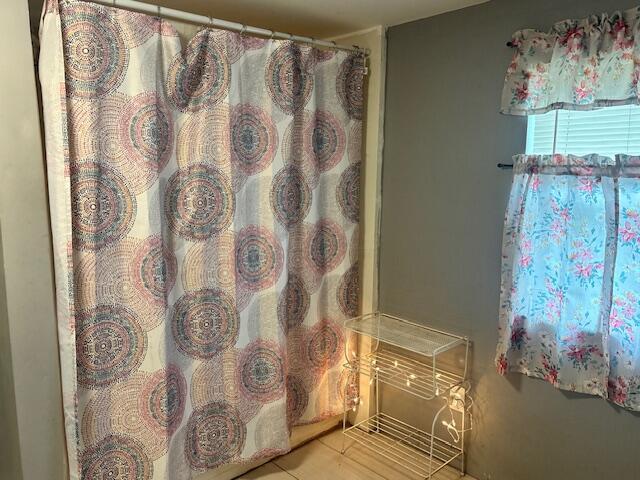 1152 Beaver Run Rd SE, Hebron, OH 43025 - full bath with a shower with curtain and tile patterned flooring