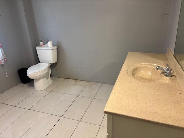 1152 Beaver Run Rd SE, Hebron, OH 43025 - half bath with vanity, toilet, and tile patterned floors