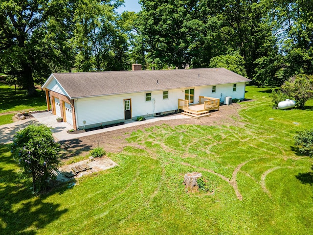 2814 Nesbitt Rd, Caledonia, OH 43314 - view of front of property featuring a wooden deck, a front yard, concrete driveway, a chimney, and an attached garage