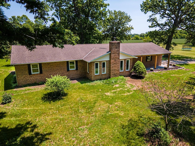2814 Nesbitt Rd, Caledonia, OH 43314 - ranch-style house featuring brick siding, a front yard, and a chimney