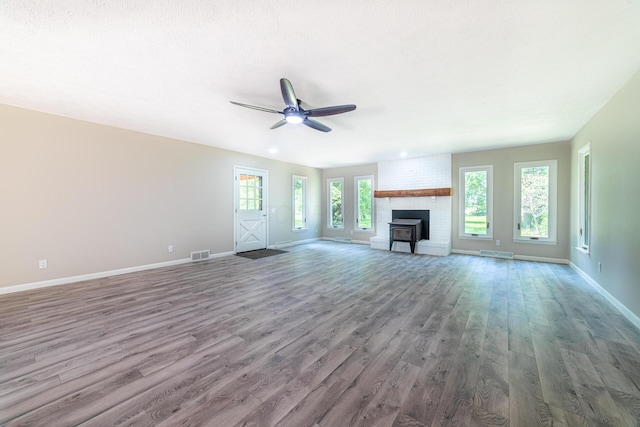 2814 Nesbitt Rd, Caledonia, OH 43314 - unfurnished living room featuring wood finished floors, ceiling fan, baseboards, and a fireplace