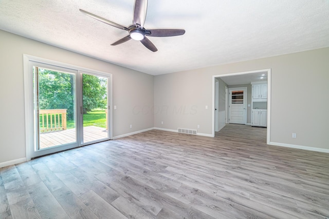 2814 Nesbitt Rd, Caledonia, OH 43314 - unfurnished room featuring ceiling fan, light wood-style floors, baseboards, and a textured ceiling