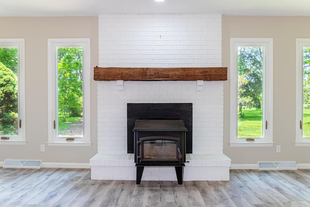 2814 Nesbitt Rd, Caledonia, OH 43314 - detailed view of wood finished floors, baseboards, and a wood stove