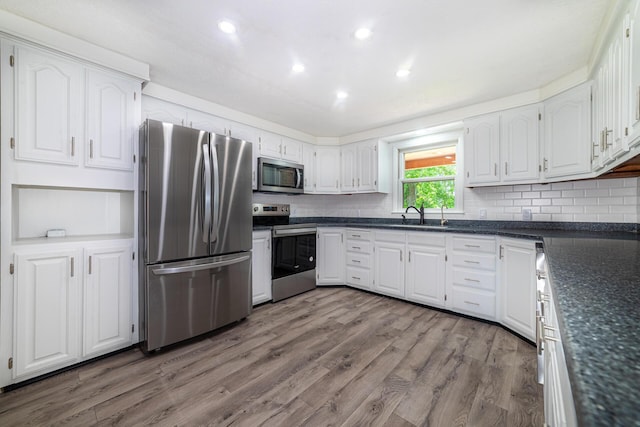 2814 Nesbitt Rd, Caledonia, OH 43314 - kitchen with stainless steel appliances, white cabinetry, tasteful backsplash, wood finished floors, and recessed lighting