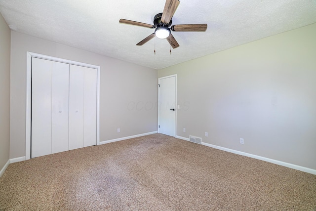 2814 Nesbitt Rd, Caledonia, OH 43314 - unfurnished bedroom featuring carpet flooring, baseboards, a closet, a textured ceiling, and ceiling fan