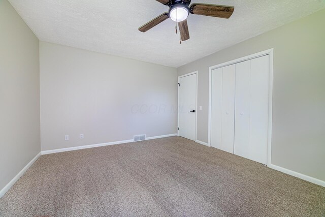 2814 Nesbitt Rd, Caledonia, OH 43314 - unfurnished bedroom with carpet flooring, a closet, baseboards, a textured ceiling, and ceiling fan