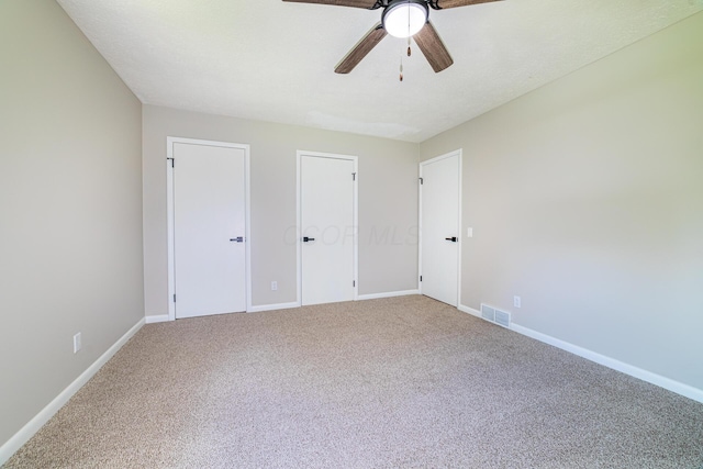 2814 Nesbitt Rd, Caledonia, OH 43314 - unfurnished bedroom with carpet floors, baseboards, a ceiling fan, and multiple closets