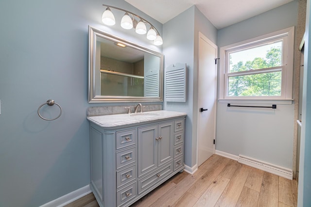 2814 Nesbitt Rd, Caledonia, OH 43314 - full bathroom featuring baseboard heating, baseboards, vanity, wood finished floors, and an enclosed shower