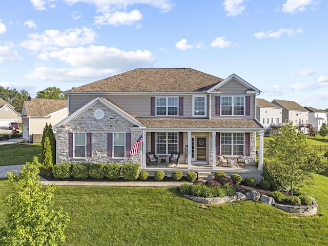 607 Green Forest Pl, Lithopolis, OH 43136 - view of front of home featuring a front lawn, stone siding, and a porch