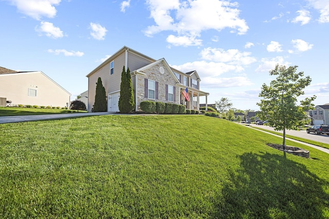 607 Green Forest Pl, Lithopolis, OH 43136 - view of front facade featuring stone siding, driveway, a front lawn, and a garage