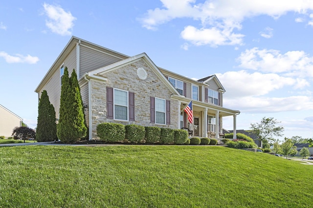 607 Green Forest Pl, Lithopolis, OH 43136 - view of front of home with stone siding, covered porch, and a front lawn