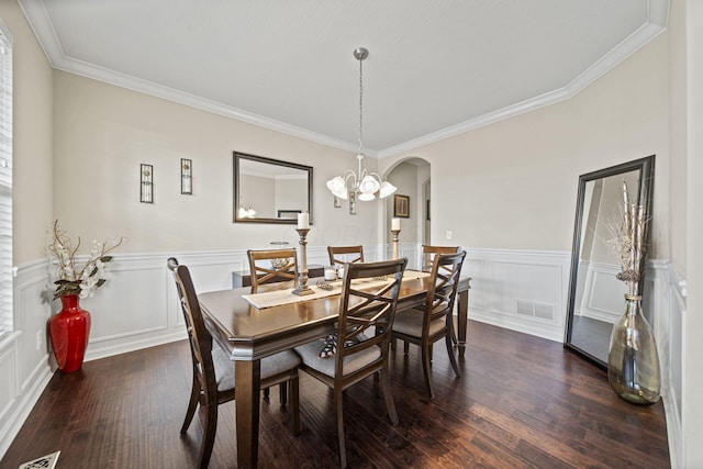 607 Green Forest Pl, Lithopolis, OH 43136 - dining room featuring arched walkways, dark wood finished floors, ornamental molding, a wainscoted wall, and a chandelier
