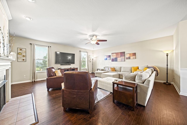607 Green Forest Pl, Lithopolis, OH 43136 - living area with a fireplace with flush hearth, a ceiling fan, dark wood-style floors, and baseboards