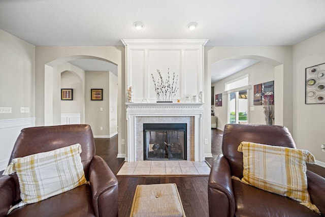 607 Green Forest Pl, Lithopolis, OH 43136 - living room featuring arched walkways, a tile fireplace, and wood finished floors