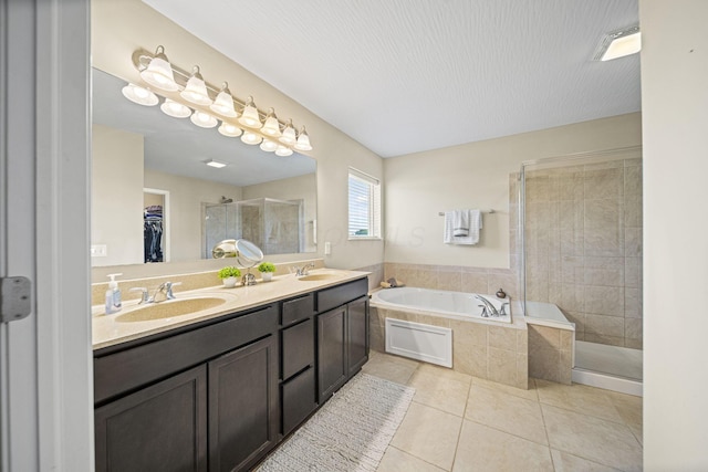 607 Green Forest Pl, Lithopolis, OH 43136 - bathroom with tile patterned flooring, a stall shower, a garden tub, double vanity, and a spacious closet