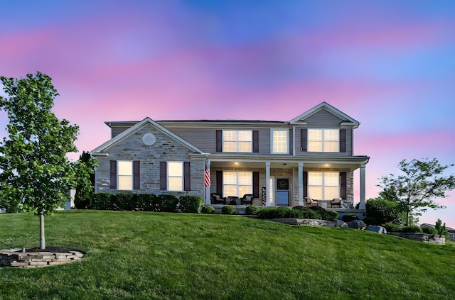 607 Green Forest Pl, Lithopolis, OH 43136 - view of front of home featuring stone siding, a front lawn, and a porch