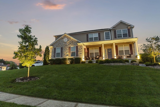607 Green Forest Pl, Lithopolis, OH 43136 - craftsman house with a porch, a front yard, and stone siding