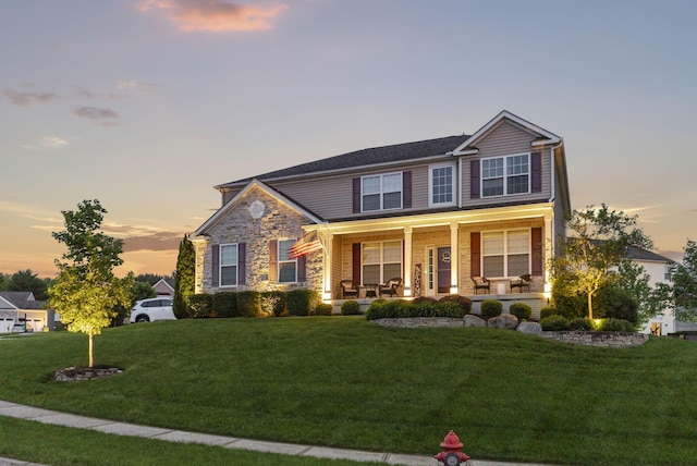 607 Green Forest Pl, Lithopolis, OH 43136 - view of front of home featuring a porch, a front yard, and stone siding