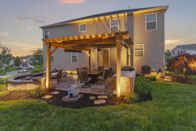 607 Green Forest Pl, Lithopolis, OH 43136 - back of property at dusk featuring a pergola, a lawn, a patio, central AC, and an outdoor fire pit