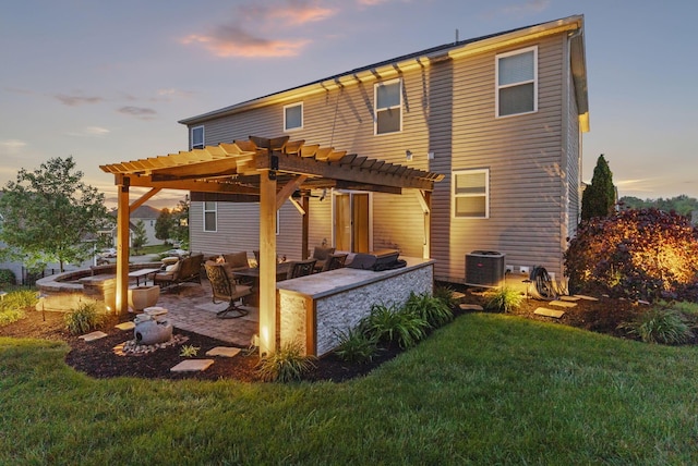 607 Green Forest Pl, Lithopolis, OH 43136 - back of house at dusk with a pergola, a yard, an outdoor living space with a fire pit, central AC, and a patio