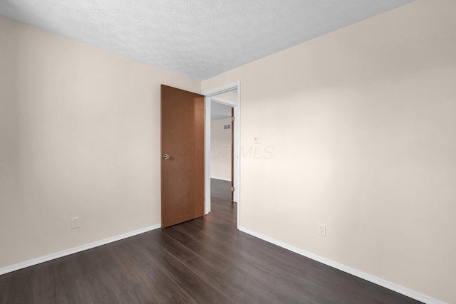 1235 Belle Meade Pl, Westerville, OH 43081 - empty room featuring dark wood-type flooring, a textured ceiling, and baseboards