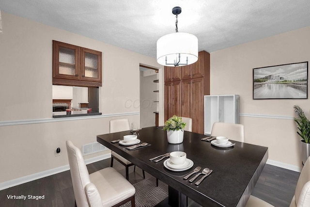 1235 Belle Meade Pl, Westerville, OH 43081 - dining room with wood finished floors, baseboards, a chandelier, and a textured ceiling