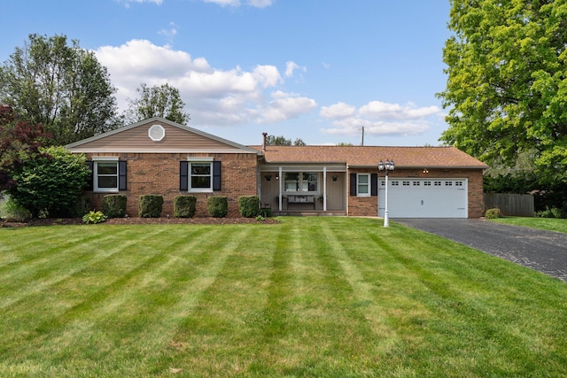 6235 George Fox Dr, Galloway, OH 43119 - single story home with asphalt driveway, an attached garage, brick siding, and a porch