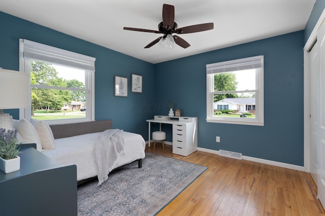 6235 George Fox Dr, Galloway, OH 43119 - bedroom with multiple windows, hardwood / wood-style flooring, a closet, and ceiling fan